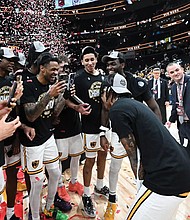 VCU players celebrate after defeating George Mason 68-63 in the Atlantic 10 Championship at Capital One Arena in Washington, D.C. The win secured the Rams an automatic bid to the 2025 NCAA Tournament, where they will face BYU in the first round.