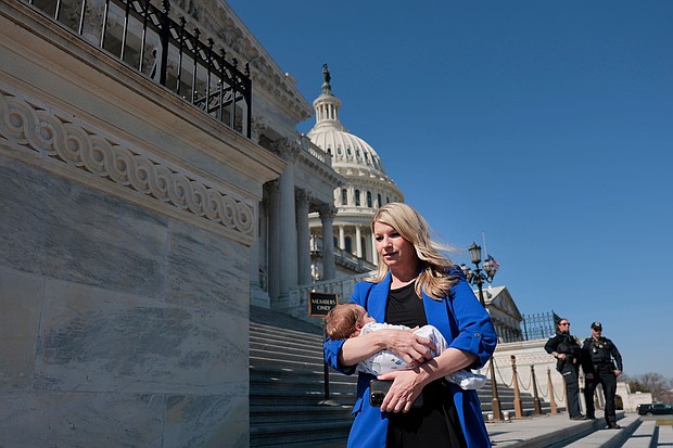 Rep. Brittany Pettersen holds her one-month old baby Sam as she departs during a series of votes at the Capitol on March 11, in Washington, DC.
Mandatory Credit:	Anna Moneymaker/Getty Images via CNN Newsource