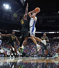 Duke's Cooper Flagg attempts a shot while guarded by Baylor's Norchad Omier during a March Madness second round game.
Mandatory Credit:	Jared C. Tilton/Getty Images via CNN Newsource