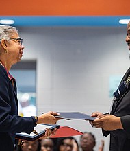 Henry L. Marsh III Elementary Principal Cornelius Smith presents proclamations to Nadine Marsh-Carter, daughter of the late state Sen. Henry L. Marsh III during the Elementary School’s celebration.