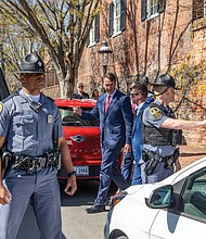 Gov. Glenn Youngkin was met with loud protests as he exited the back of the church onto Grace Street at about 3 p.m.