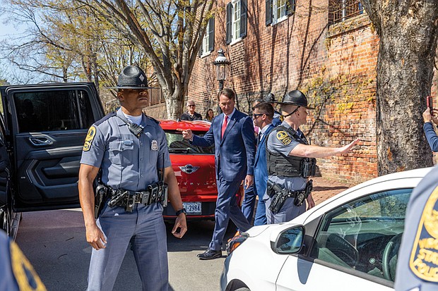 Gov. Glenn Youngkin was met with loud protests as he exited the back of the church onto Grace Street at about 3 p.m.
