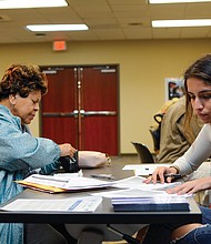 Student volunteers help a citizen with tax filing during a recent event.
