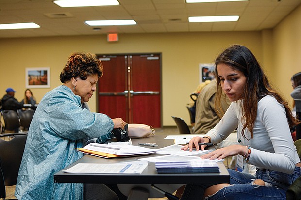 Student volunteers help a citizen with tax filing during a recent event.