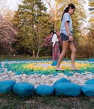 Hannah Bishop and her daughters, Salomé and Sol Perez, explore The Barefoot Circle, a circular rock garden created by their husband and father, artist Alfonso Pérez Acosta. The installation is part of the new exhibition “Homes & Habitats” at Lewis Ginter Botanical Garden, which continues through Sept. 28.