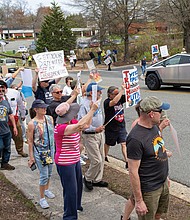 Protesters rally near the Tesla dealership at Stillman Parkway and Broad Street in Glen Allen on March 29, opposing Elon Musk’s purging of the government under President Trump. The protest was part of a nation-wide effort.