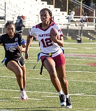 A player from the VUU flag football team runs with the ball as a Fayetteville State player gives chase during the first-ever CIAA Flag Football Roundup at Virginia Union University on March 28.
