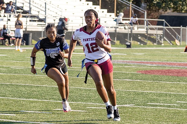 A player from the VUU flag football team runs with the ball as a Fayetteville State player gives chase during the first-ever CIAA Flag Football Roundup at Virginia Union University on March 28.