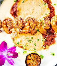 Sole Lounge’s brunch Shrimp & Grits features six succulent shrimp served with tomato sauce, turkey sausage, and creamy grits.

Photo: Visual Influence