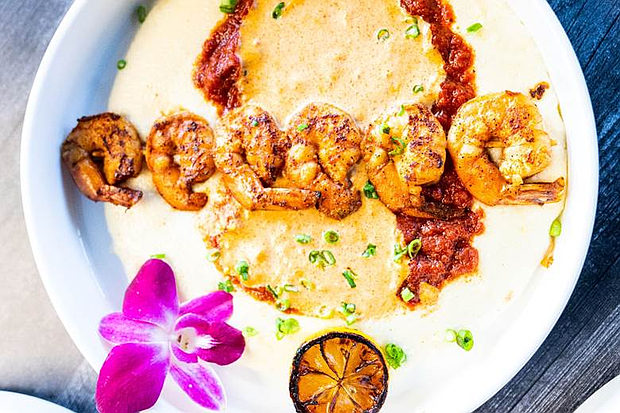 Sole Lounge’s brunch Shrimp & Grits features six succulent shrimp served with tomato sauce, turkey sausage, and creamy grits.
Photo: Visual Influence