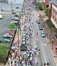 Protesters fill Mainstreet during the “Hands Off!” rally on Saturday, April 6, marching from Capitol Square to Monroe Park in opposition to the influence of President Trump and Elon Musk on politics and civil rights.