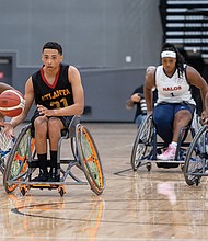 BlazeSports Jr. Hawks player Daniel Graham (21) takes the ball up the court during Game 7 of the varsity division at the National Wheelchair Basketball Junior Championships on Saturday, April 6, at Henrico Sports & Events Center. The tournament, hosted by Sportable in partnership with the National Wheelchair Basketball Association, Richmond Region Tourism and the Henrico Sports & Entertainment Authority, featured teams from across the U.S. competing for national titles. Adult division play continues April 11 through 14.