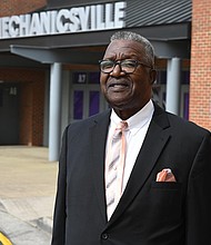 Norbert Lee stands outside Mechanicsville High School, formerly Lee-Davis High, where he helped integrate the student body 60 years ago. Lee and other trailblazing classmates will be honored with commemorative plaques this month.