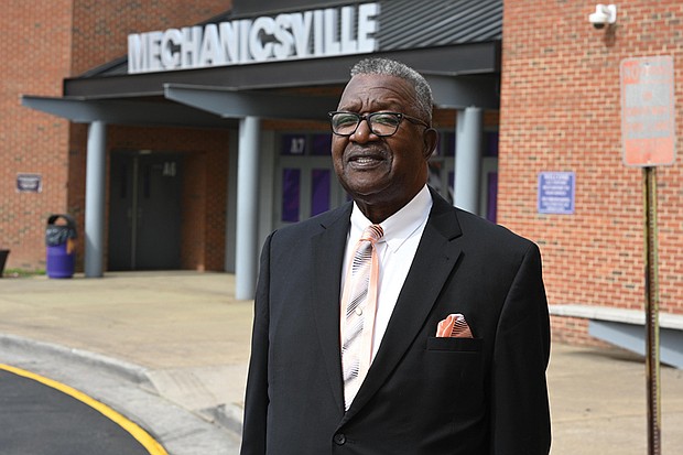 Norbert Lee stands outside Mechanicsville High School, formerly Lee-Davis High, where he helped integrate the student body 60 years ago. Lee and other trailblazing classmates will be honored with commemorative plaques this month.