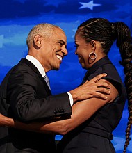 Former U.S. first lady Michelle Obama greets her husband, former U.S. President Barack Obama, on stage during Day 2 of the Democratic National Convention (DNC) in Chicago, Illinois, in August 2024.
Mandatory Credit:	Alyssa Pointer/Reuters via CNN Newsource