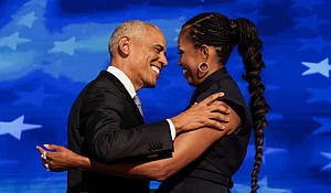 Former U.S. first lady Michelle Obama greets her husband, former U.S. President Barack Obama, on stage during Day 2 of the Democratic National Convention (DNC) in Chicago, Illinois, in August 2024.
Mandatory Credit:	Alyssa Pointer/Reuters via CNN Newsource