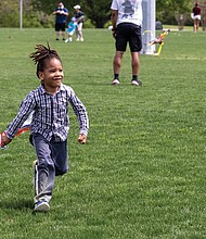 Solomon, 4, picks up speed during Kite Day at Dorey Park on Sunday, Apr. 6. The event featured train rides, kite demonstrations and a children’s entrepreneurship market. Attendees could also make and decorate their own kites if they didn’t bring one.