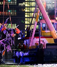 Emergency personnel work at the scene of a helicopter crash on the Hudson River near lower Manhattan in New York, as seen from Newport, New Jersey, U.S., April 10, 2025.
Mandatory Credit:	Eduardo Munoz/Reuters via CNN Newsource