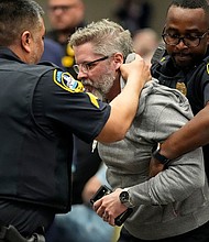 Police remove a protester from an event with Rep. Marjorie Taylor Greene in Acworth, Georgia, on Tuesday.
Mandatory Credit:	Mike Stewart/AP via CNN Newsource