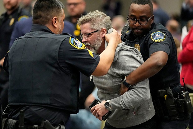 Police remove a protester from an event with Rep. Marjorie Taylor Greene in Acworth, Georgia, on Tuesday.
Mandatory Credit:	Mike Stewart/AP via CNN Newsource