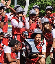 Winston-Salem State University players celebrate with the championship trophy after winning the CIAA’s first women’s flag football title April 6 at Johnson C. Smith University in Charlotte. The Rams defeated Fayetteville State 9-6 in the final.