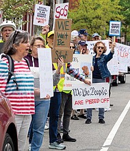 Demonstrators gather outside the Social Security Administration office on West Cary Street in Richmond for a “Hands Off Social Security” rally.