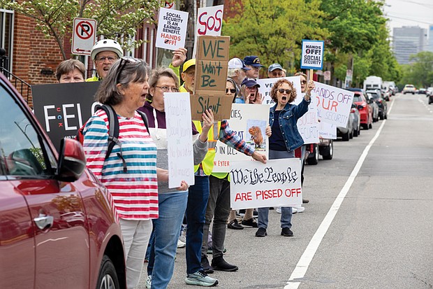 Demonstrators gather outside the Social Security Administration office on West Cary Street in Richmond for a “Hands Off Social Security” rally.