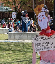 A protester’s sign hangs at VCU’s Park Plaza on Monday, April 4, during the Hands Off Our Students Walkout. The rally was held in response to two VCU students and one recent graduate having their visas revoked and called on the university to support those affected and end the presence federal authorities on campus.