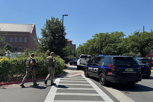 Law enforcement vehicles are stationed outside of Florida State University’s student union building after a shooting on the university campus on Thursday.
Mandatory Credit:	Kate Payne/AP via CNN Newsource
