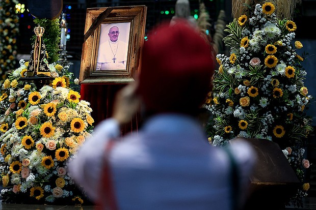 A mourner looks upon a portrait of the late Pope Francis at the Rio de Janeiro Metropolitan Cathedral, in Brazil, on April 21. The funeral for the 88-year-old pontiff will take place at the Vatican, on Saturday.
Mandatory Credit:	Buda Mendes/Getty Images via CNN Newsource