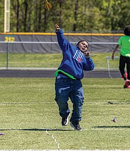 With focus and power, Kamar — a sixth grader at Martin Luther King Jr. Middle School - launches the javelin during competition.