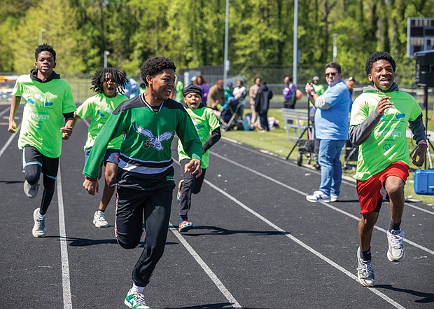 Thomas H. Henderson Middle School seventh-and eighth-graders Tyion (front left), Aiden (front right), Karell, Judah and Micah (back left to right) compete in the 50-meter race.
