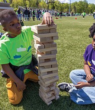 Boushall Middle School students Cali (right), a seventh-grader, and Dy’lon (left), a sixth-grader, face off in a game of Jenga.