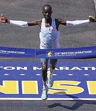 John Korir of Kenya breaks the tape to win the Boston Marathon, Monday, April 21, in Boston.
