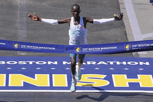 John Korir of Kenya breaks the tape to win the Boston Marathon, Monday, April 21, in Boston.
