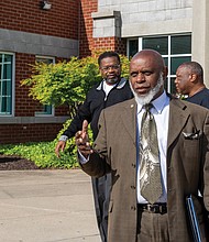 Charles Willis, right, founder of United Communities Against Crime, arrives at the Oliver
Hill Courts Building April 22 for his arraignment on charges related to a domestic
incident involving his fiancée.
