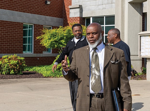 Charles Willis, right, founder of United Communities Against Crime, arrives at the Oliver
Hill Courts Building April 22 for his arraignment on charges related to a domestic
incident involving his fiancée.