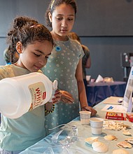 During the Science Museum of Virginia’s Earth Day Festival on Saturday, April 19, Vivi, 10, and her sister Nalani, 7, learned how ocean acidification — caused by increased carbon dioxide levels — harms marine ecosystems.