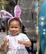Ailani Irizarry, 2, delights in a flurry of bubbles along Monument Avenue during the Easter on Parade celebration Sunday, April 20.