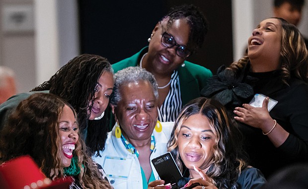 Women snap a selfie after a group activity at Virginia Credit Union’s Financial Success for Women Summit on April 15.
