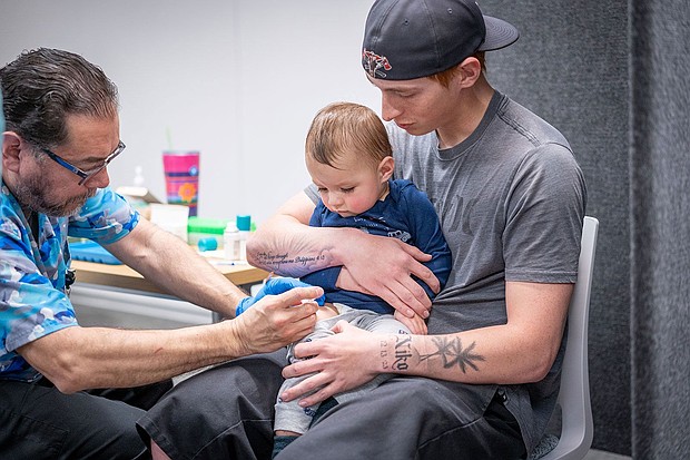 A study says US may have millions more measles cases over next 25 years if childhood vaccination rates continue to decline, and seen here Ethan Turner holds his son, while he gets the MMR vaccine from Raynard Covarrubio at a vaccine clinic put on by Lubbock Public Health on March 1.
Mandatory Credit:	Jan Sonnenmair/Getty Images/File via CNN Newsource