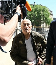Defendant Yunice Abbas and his lawyer arrive for the start of the trial in Paris on Monday, April 28, 2025.
Mandatory Credit:	Bertrand Guay/AFP/Getty Images via CNN Newsource
