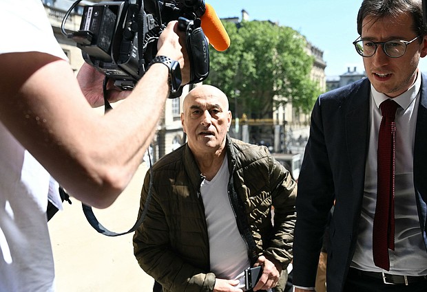 Defendant Yunice Abbas and his lawyer arrive for the start of the trial in Paris on Monday, April 28, 2025.
Mandatory Credit:	Bertrand Guay/AFP/Getty Images via CNN Newsource
