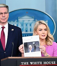 White House Press Secretary Karoline Leavitt, joined by Secretary of Treasury Scott Bessent, holds a news article on Amazon CEO Jeff Bezos during a briefing Tuesday.
Mandatory Credit:	Mandel Ngan/AFP/Getty Images via CNN Newsource