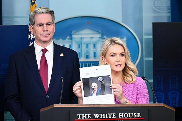 White House Press Secretary Karoline Leavitt, joined by Secretary of Treasury Scott Bessent, holds a news article on Amazon CEO Jeff Bezos during a briefing Tuesday.
Mandatory Credit:	Mandel Ngan/AFP/Getty Images via CNN Newsource