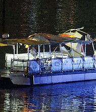 Investigators search the wreckage of a Clearwater ferry after a boat crashed into it, causing multiple injuries near the Clearwater Memorial Causeway Bridge on Sunday.
Mandatory Credit:	Douglas R. Clifford/Tampa Bay Times/AP via CNN Newsource