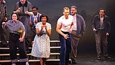 Flora Hawk as Mildred Jeter Loving and Jonathan Michie as Richard Loving share a powerful moment on stage, joined by members of the chorus, in a scene from the world premiere production of “Loving v. Virginia.”
