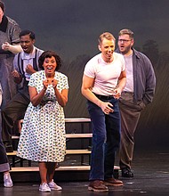 Flora Hawk as Mildred Jeter Loving and Jonathan Michie as Richard Loving share a powerful moment on stage, joined by members of the chorus, in a scene from the world premiere production of “Loving v. Virginia.”