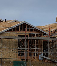A construction worker helps builds a roof on a residential homes in Irvine, California, on March 28.
Mandatory Credit:	Mike Blake/Reuters via CNN Newsource