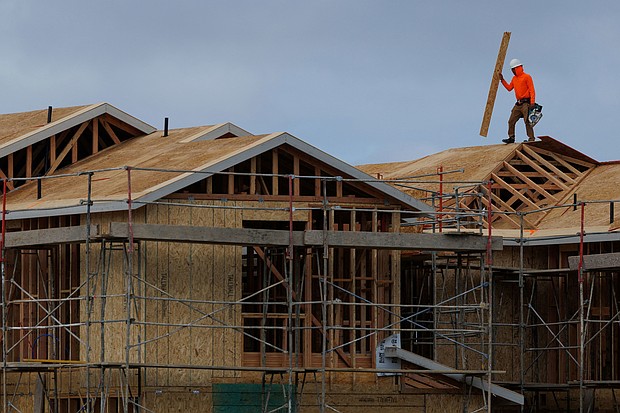 A construction worker helps builds a roof on a residential homes in Irvine, California, on March 28.
Mandatory Credit:	Mike Blake/Reuters via CNN Newsource